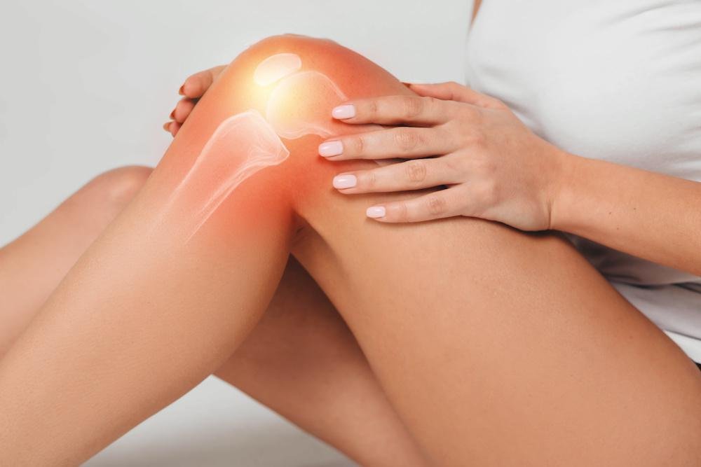 Person touching knee in an everyday comfort context